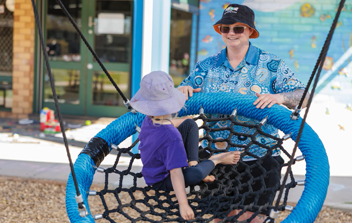 Michaela with young person on swing.