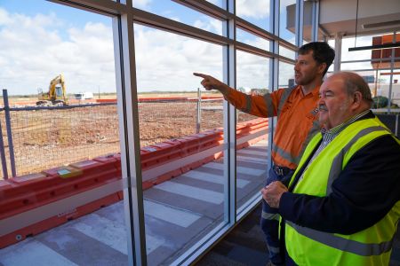 Fulton Hogan Project Manager Hayden Dutney, left, gives Mayor Phill Stone an overview of the airport runway upgrade progress.