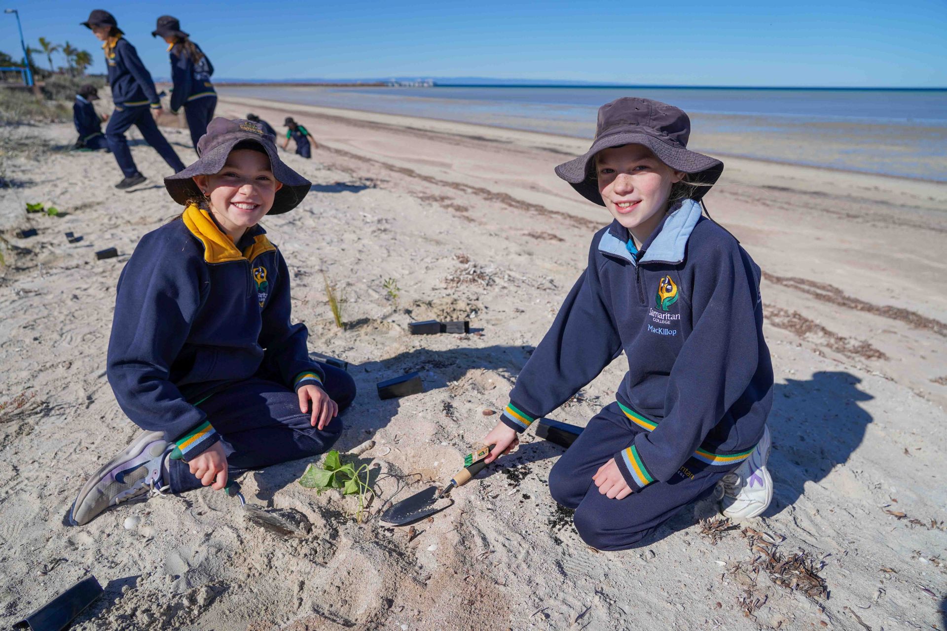 Samaritan Students planting shrubs on beach